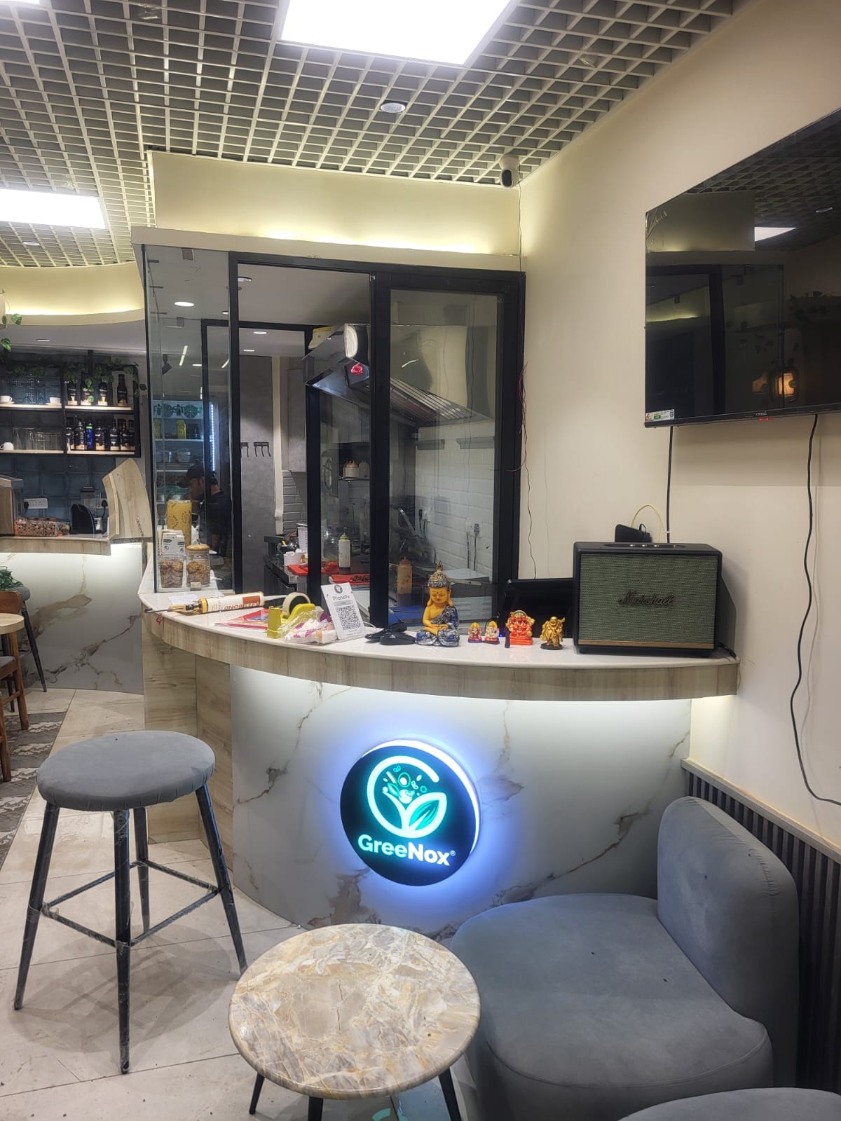 Curved backlit counter with GreeNox logo